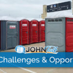 Rows of red and gray portable toilets at an event