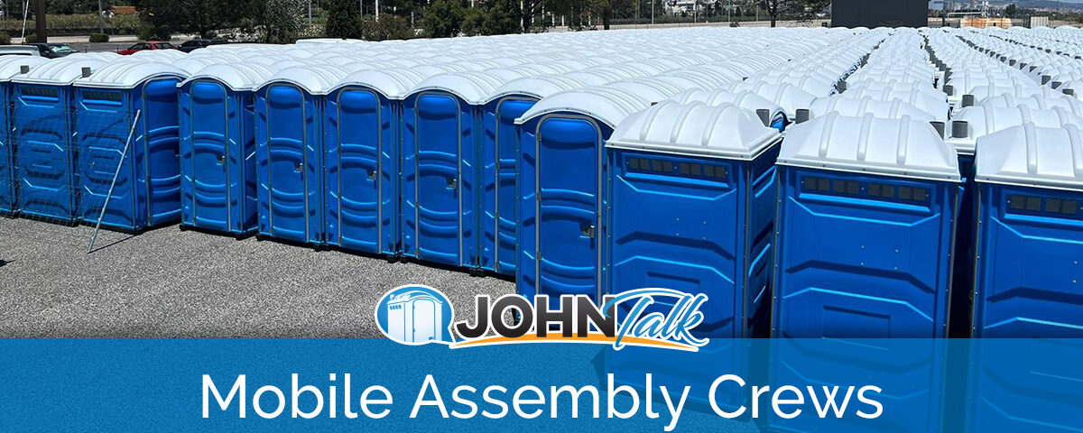 A large group of blue portable toilets