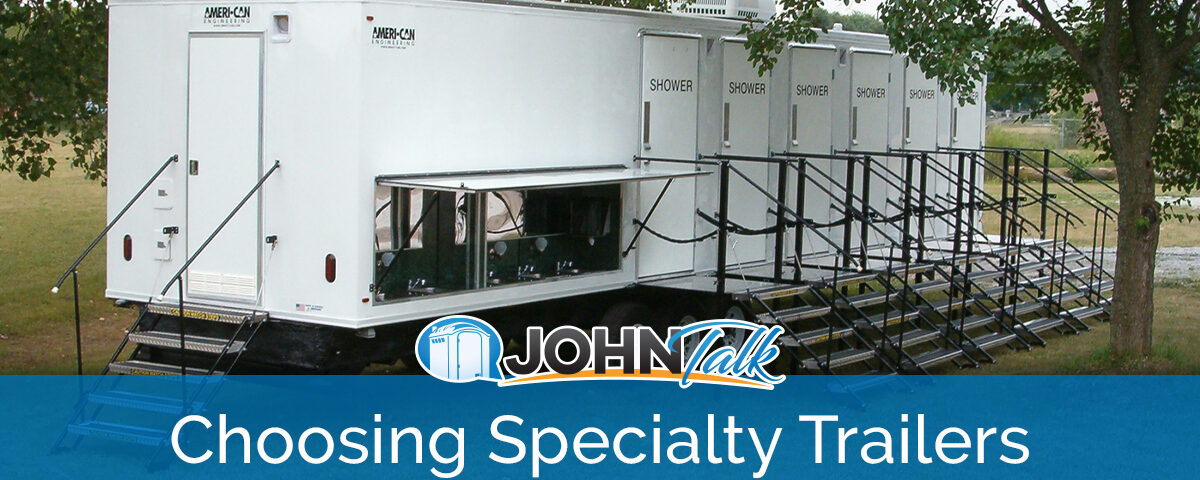 A large, white portable shower trailer