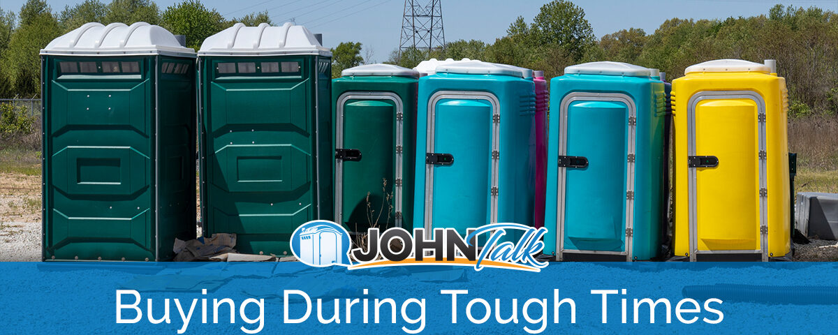 A group of portable toilets in a warehouse yard