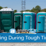 A group of portable toilets in a warehouse yard