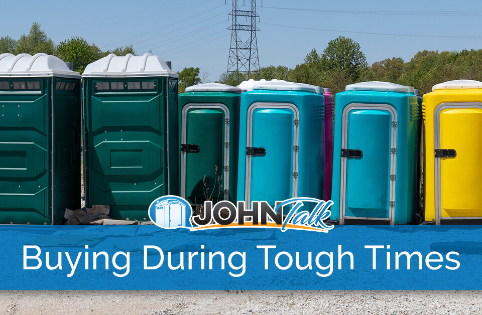 A group of portable toilets in a warehouse yard