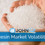 A pair of hands holding plastic resin pellets