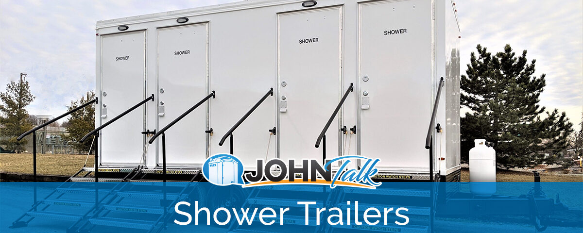 A white, four-door portable shower trailer