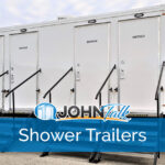 A white, four-door portable shower trailer